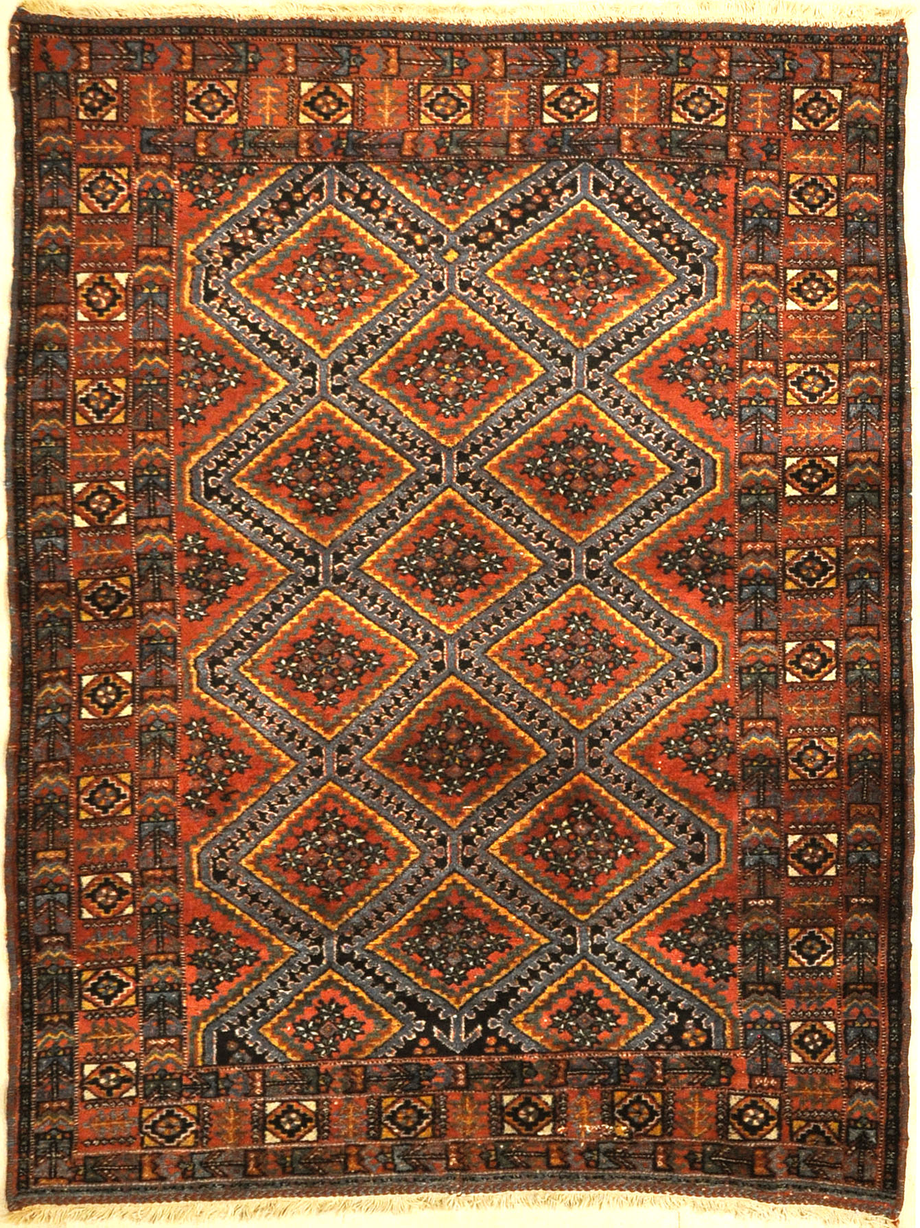 An antique Persian Afshar rug featuring a diamond pattern. A piece of genuine original woven carpet art sold by the Santa Barbara Design Center.