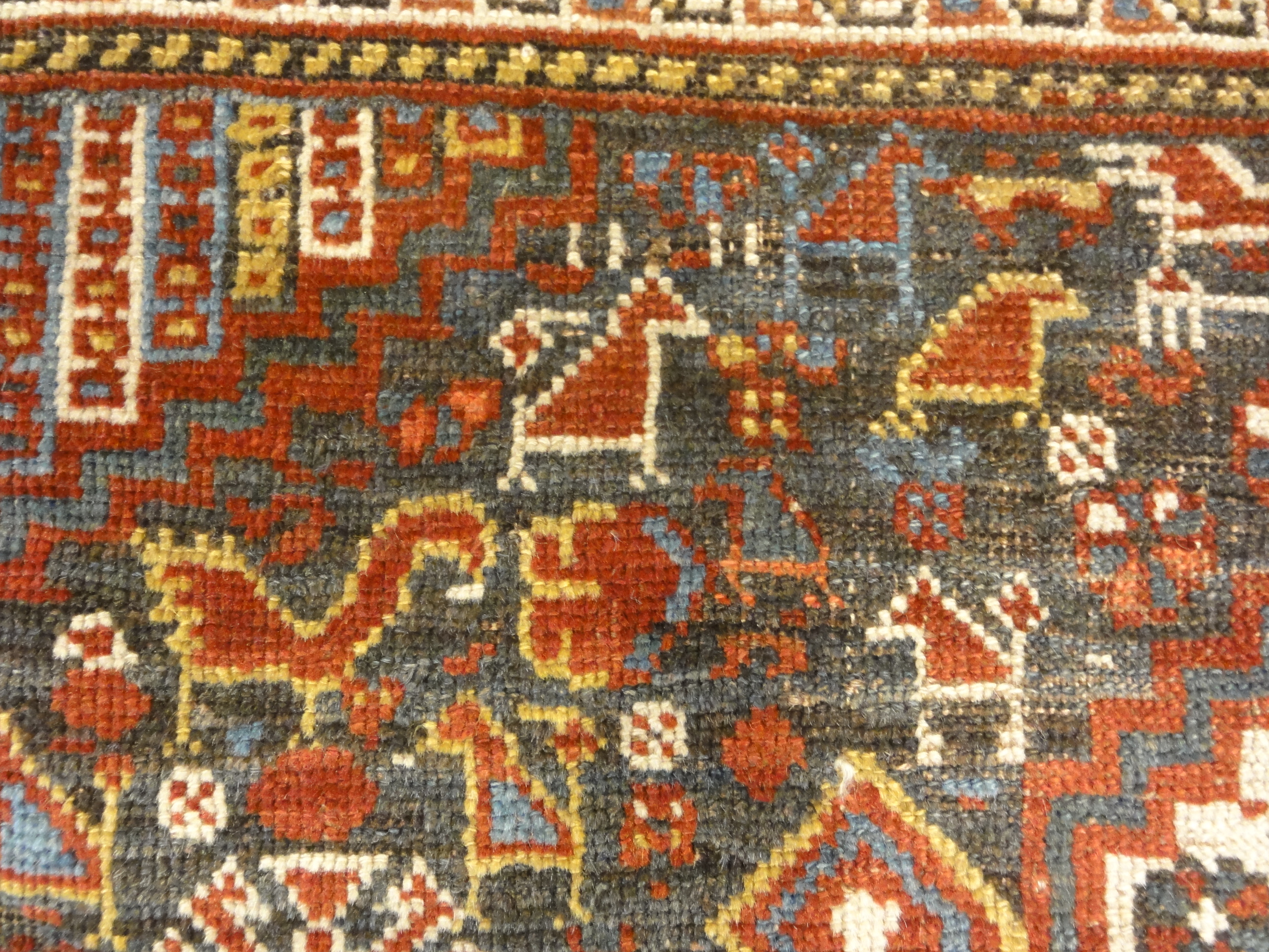 Antique Persian Khamseh Chicken Rug. A piece of genuine woven carpet art sold by Santa Barbara Design Center Rugs and More.