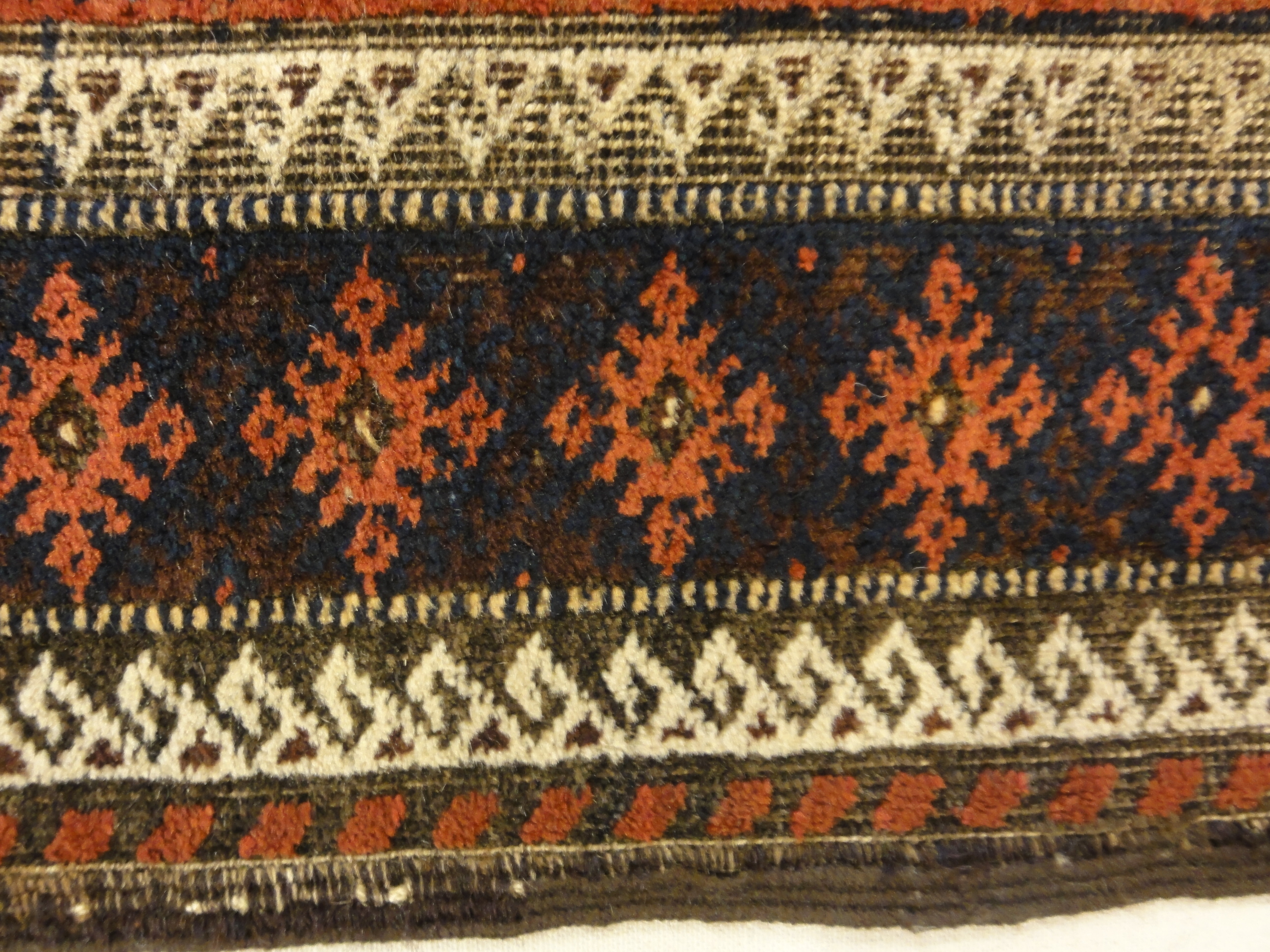 An antique and original burial Baluch dated rug. Dated on all four corners. Used as a casket covering. Sold by Santa Barbara Design Center.