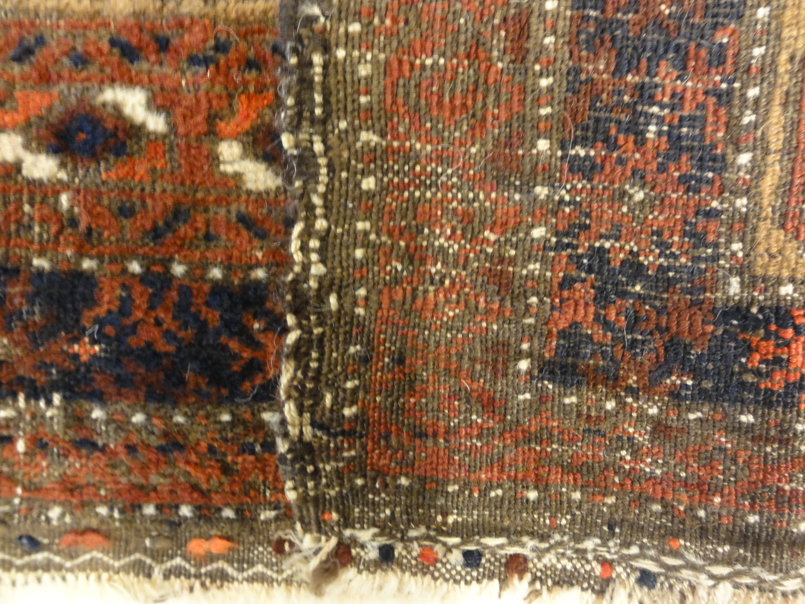 An antique, original Persian Baluch rug. A piece of genuine and authentic carpet art sold at Santa Barbara Design Center. Rugs and More.
