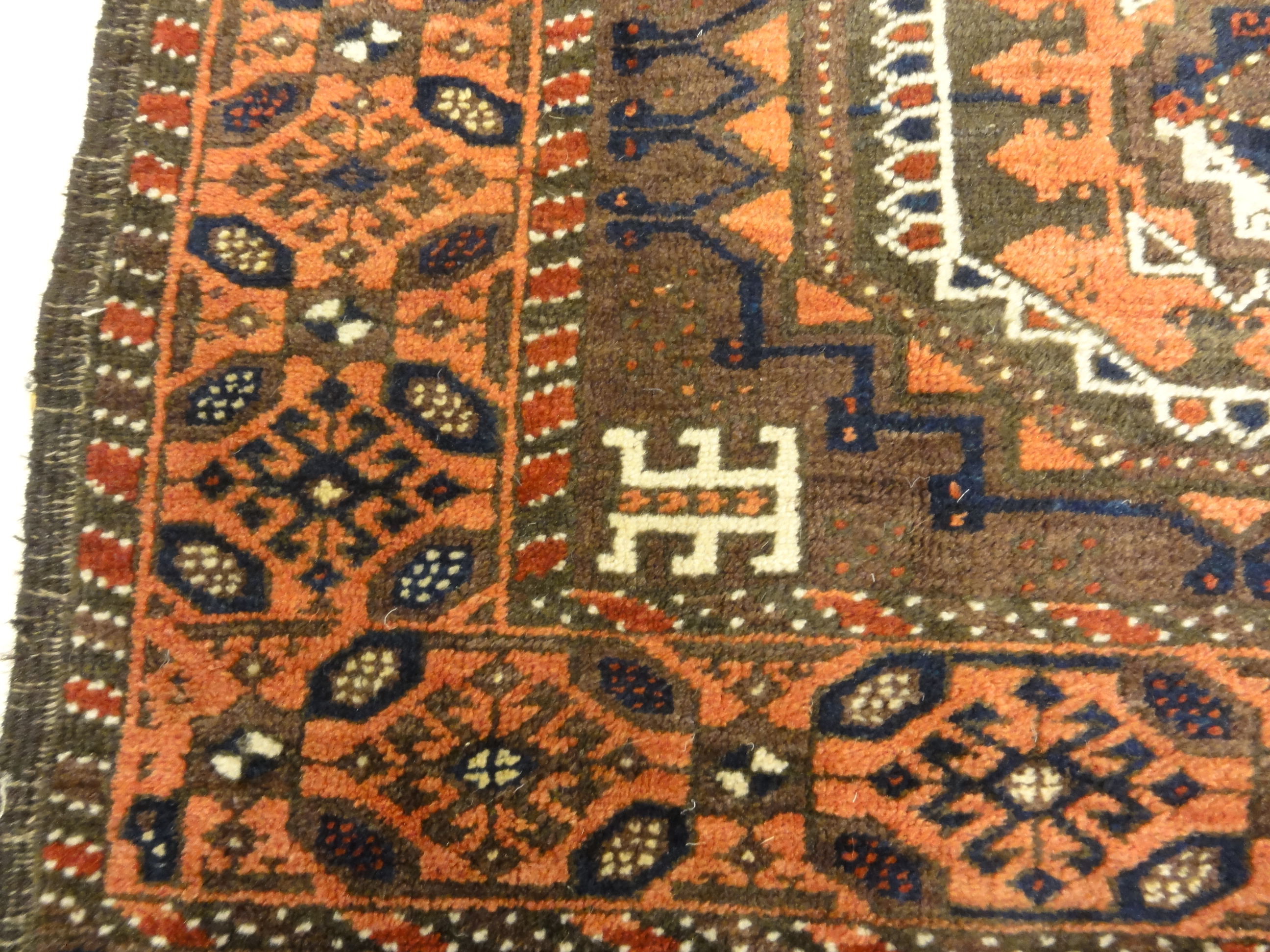 Antique Original Baluch with 3 Medallions and Unique Knotted Ends. An Afghan piece of original genuine woven carpet art sold by Santa Barbara Design Center.