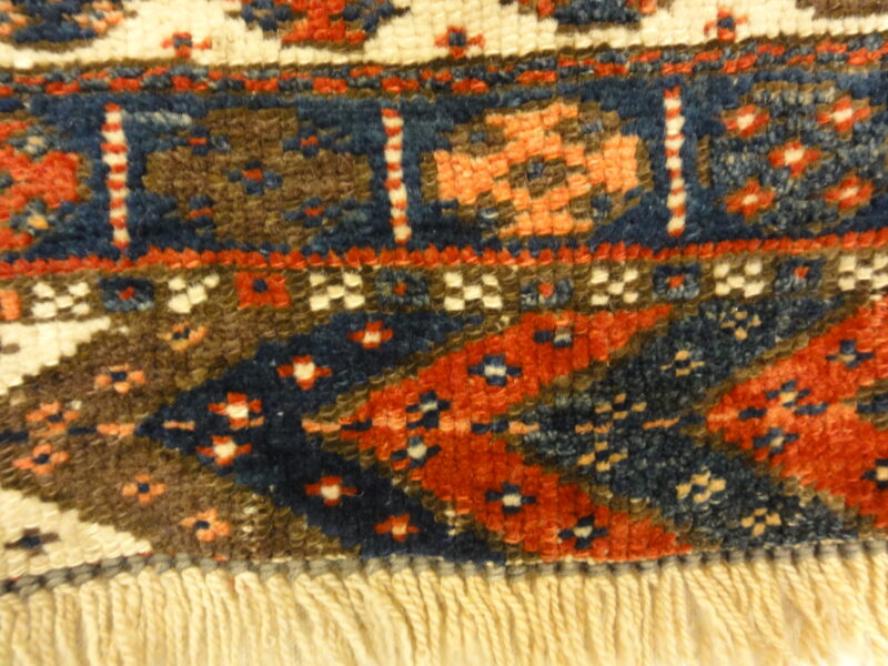 Kurdish Bagface Jaf Kurd. A genuine, antique piece of woven carpet art sold by Rugs & More in the Santa Barbara Design Center.