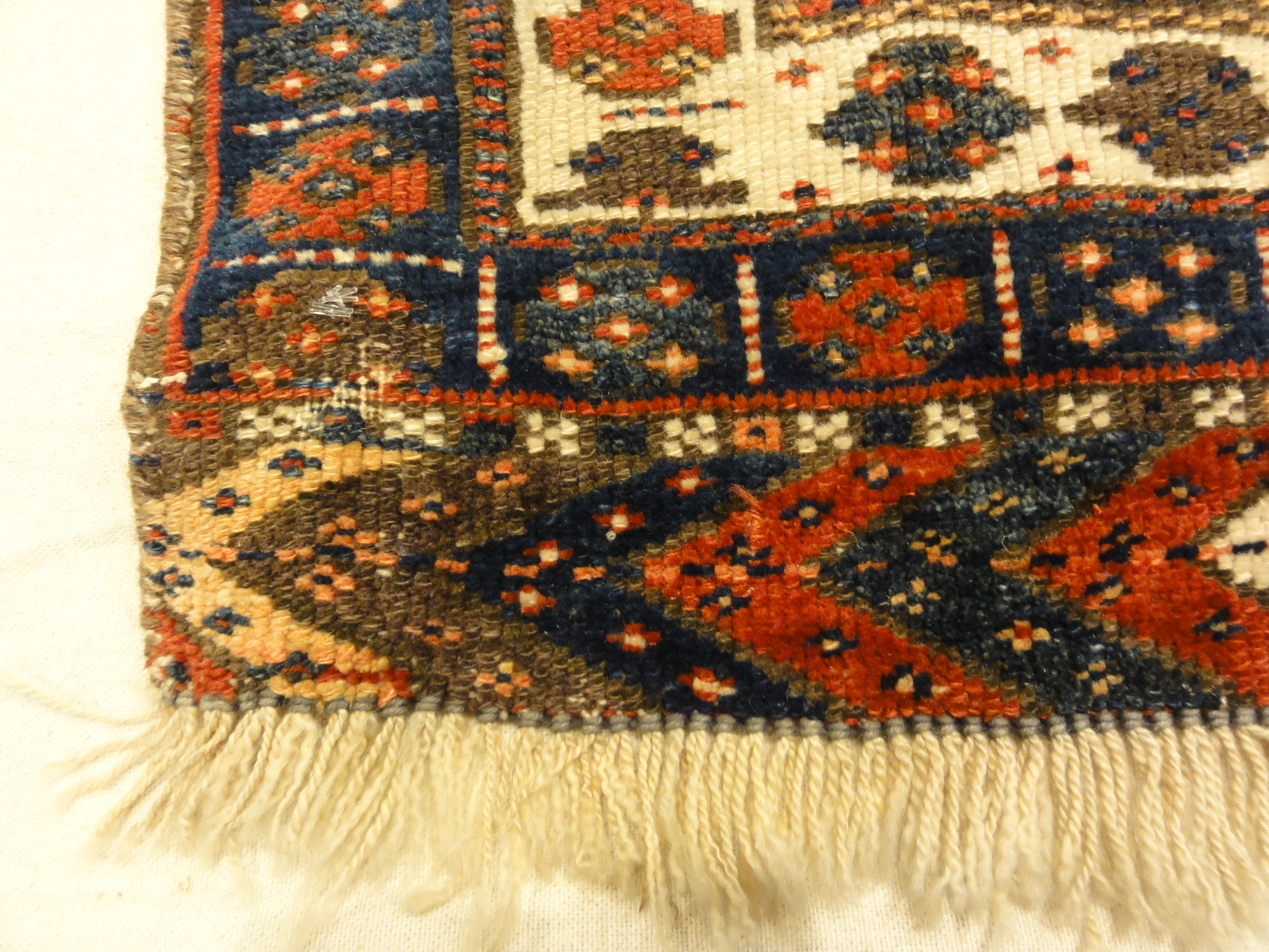 Kurdish Bagface Jaf Kurd. A genuine, antique piece of woven carpet art sold by Rugs & More in the Santa Barbara Design Center.