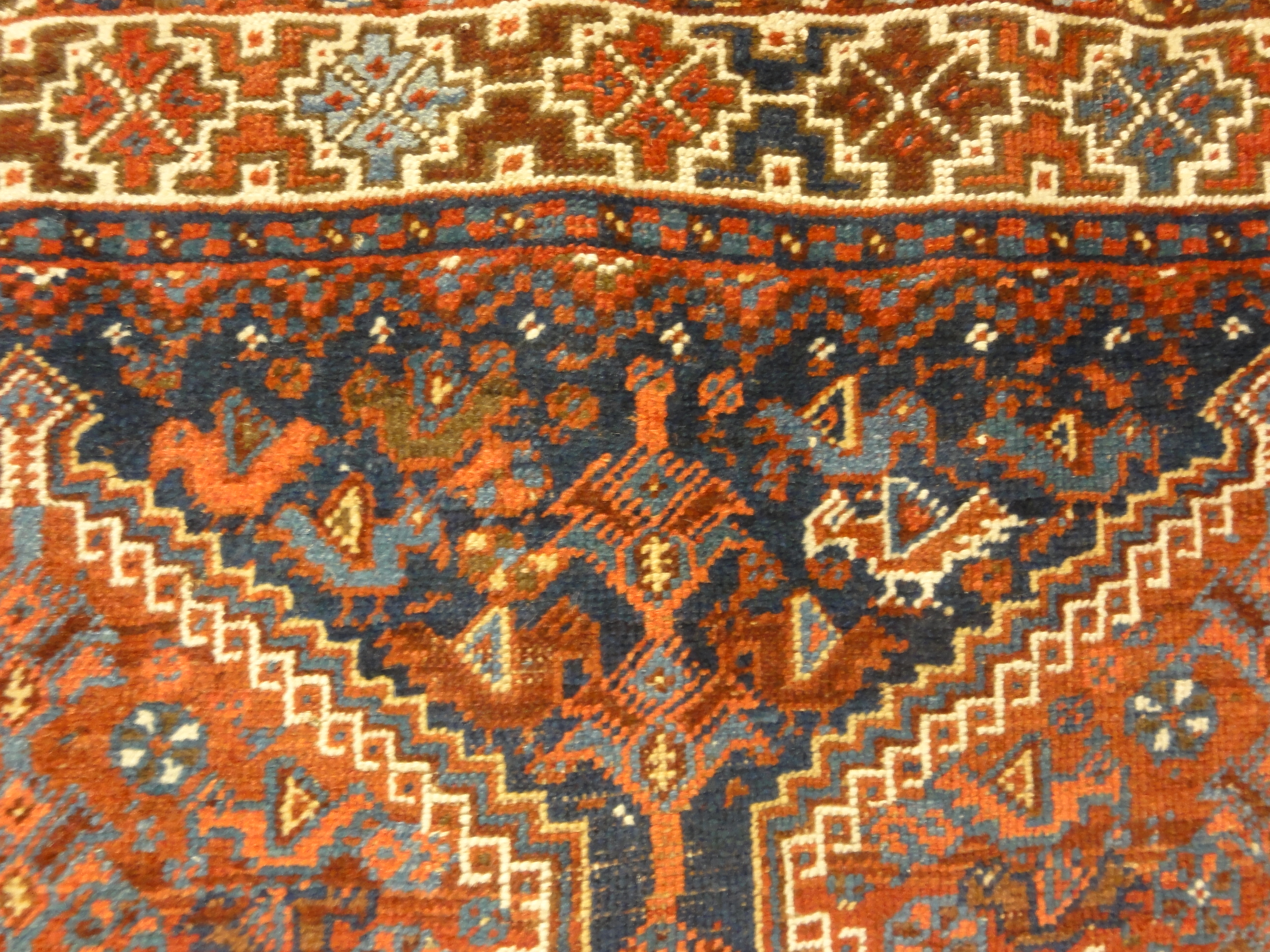 Antique Khamseh Chicken Rug. A piece of genuine authentic antique woven carpet art sold by Santa Barbara Design Center, Rugs and More.