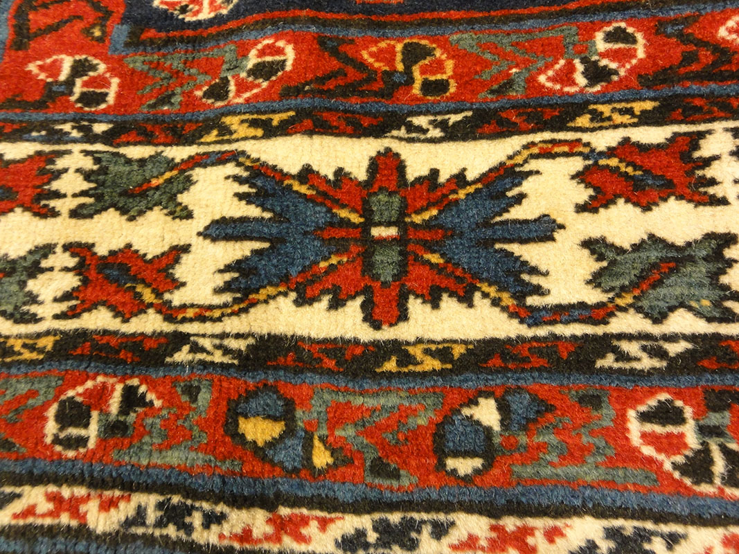 Amazing Caucasian Shirvan Baku Rug. An antique piece of woven carpet art sold by the Santa Barbara Design Center Rugs and More in Santa Barbara, California.