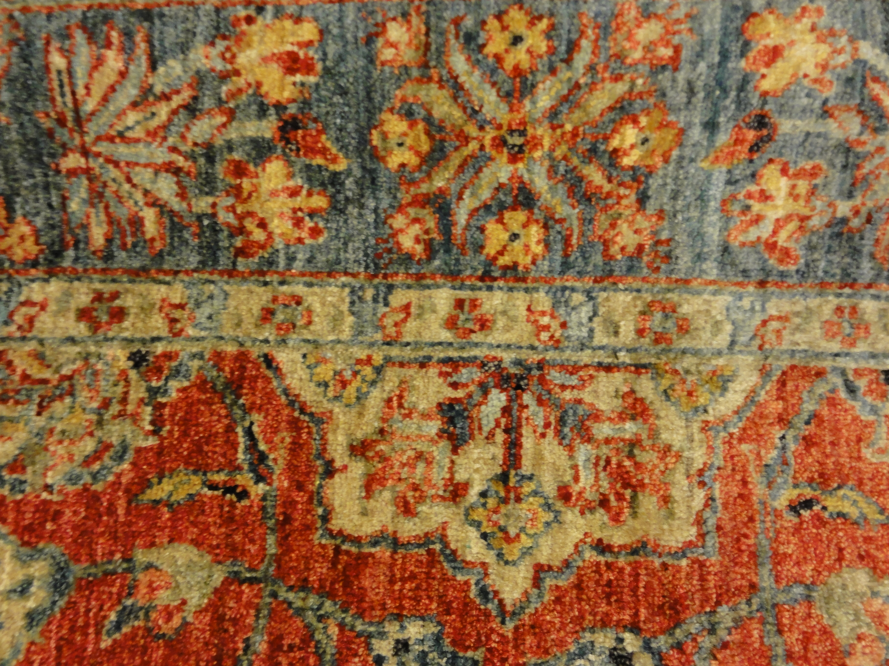 Fine Mughal Runner hand knotted of fine wool and organic dyes. Featuring reds and blues.