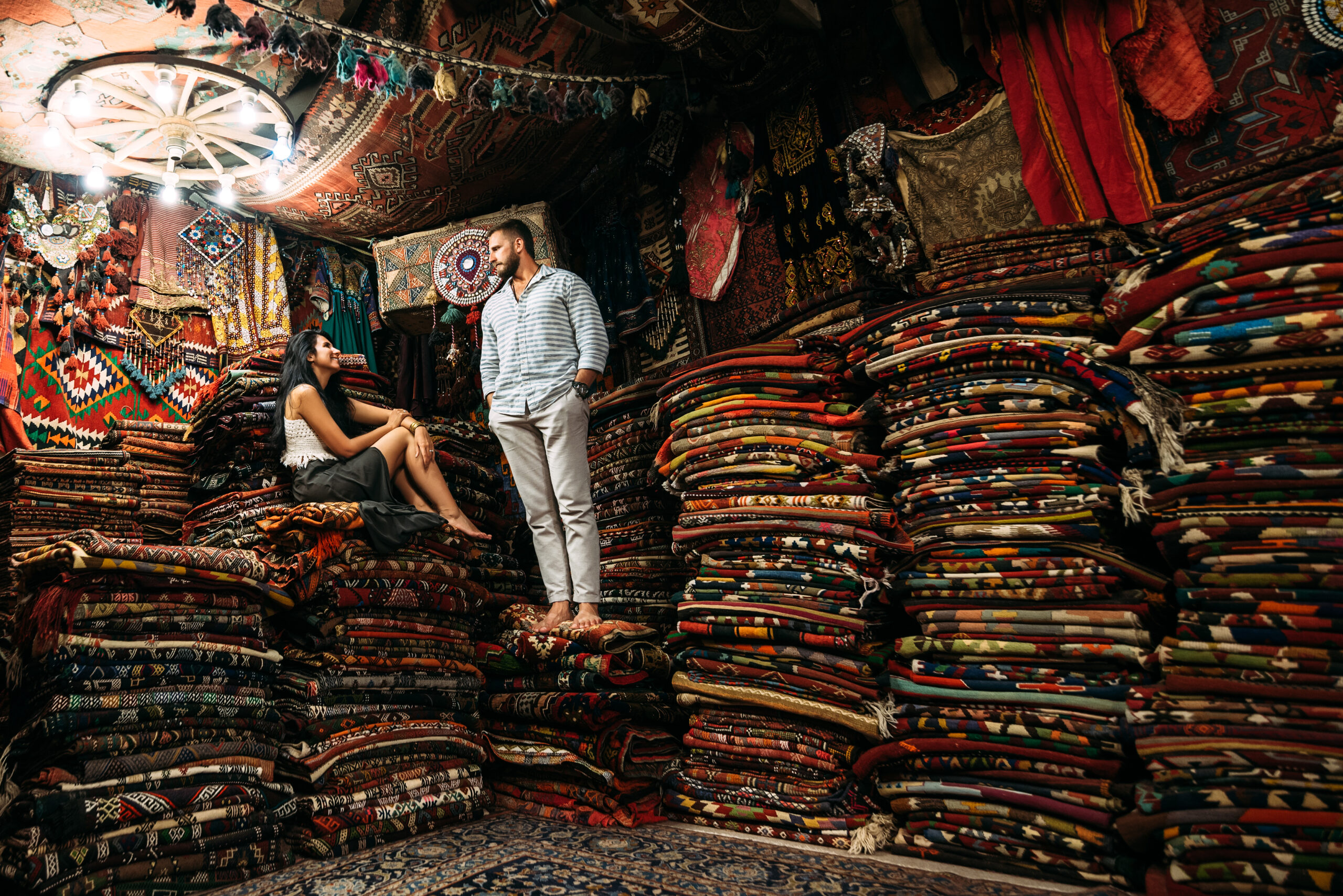 Guy and girl in the store. Couple in love in Turkey. Man and woman in the Eastern country. Gift shop. A couple in love travels. Persian shop. Tourists in store. Oriental carpet. Istanbul. Cappadocia. Rugs and More in Santa Barbara, Ca